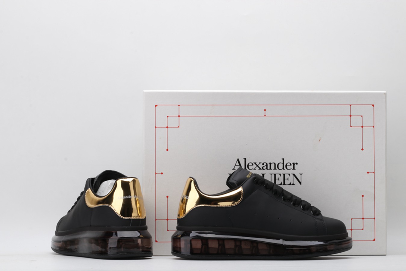 AMQ oversized sneakers black with gold heel