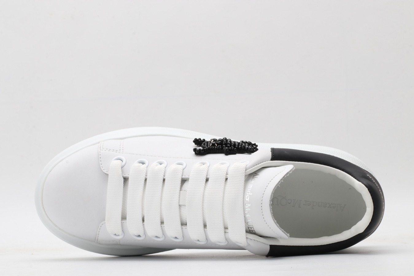 AMQ white oversized sneakers with black heel
