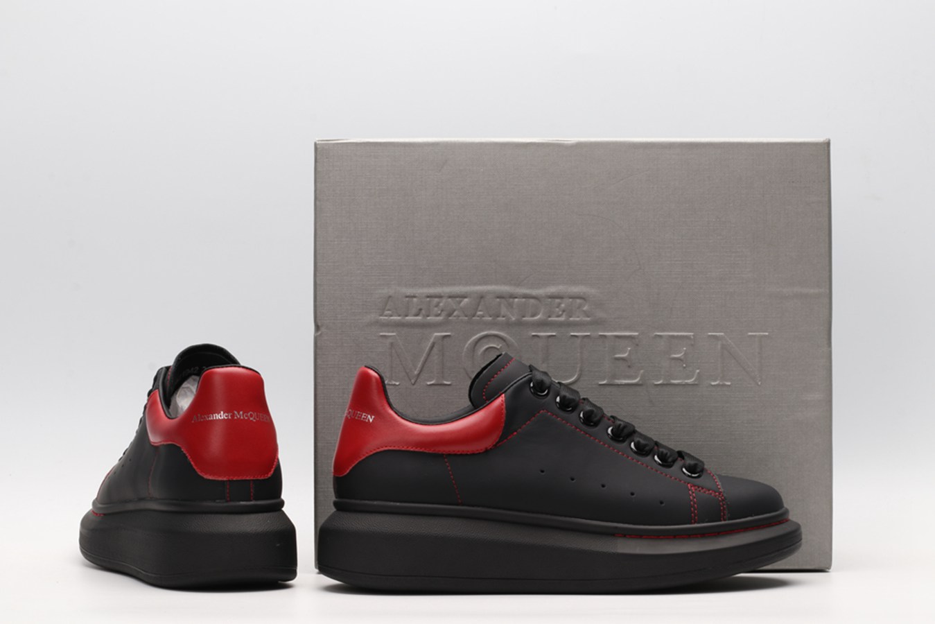 AMQ black oversized sneakers with red heel